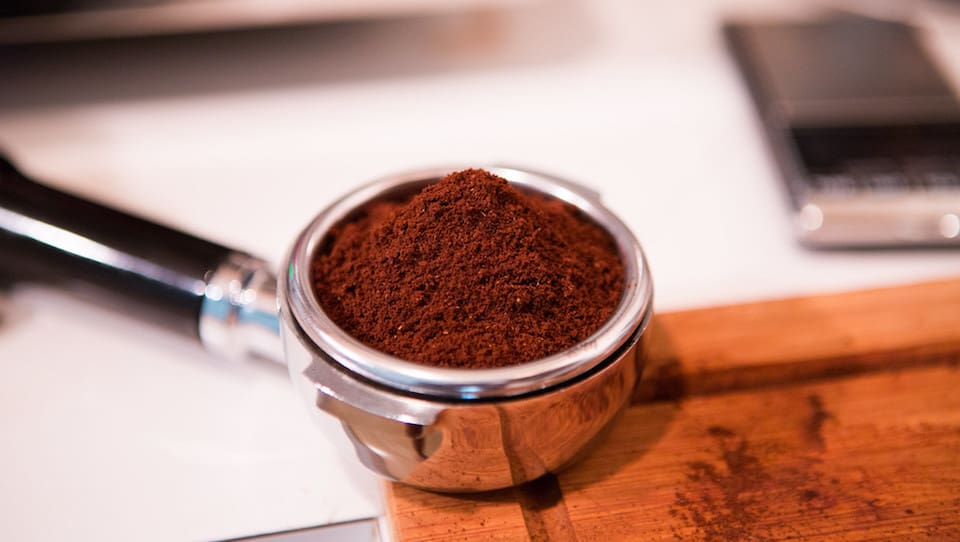 Coffee beans for espresso in portafilter