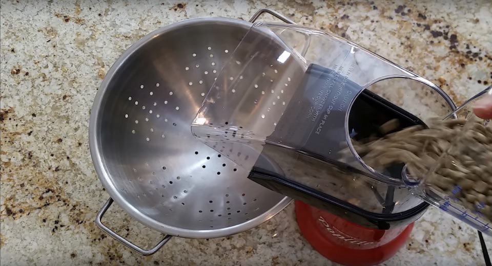 Pouring coffee beans into the popcorn popper