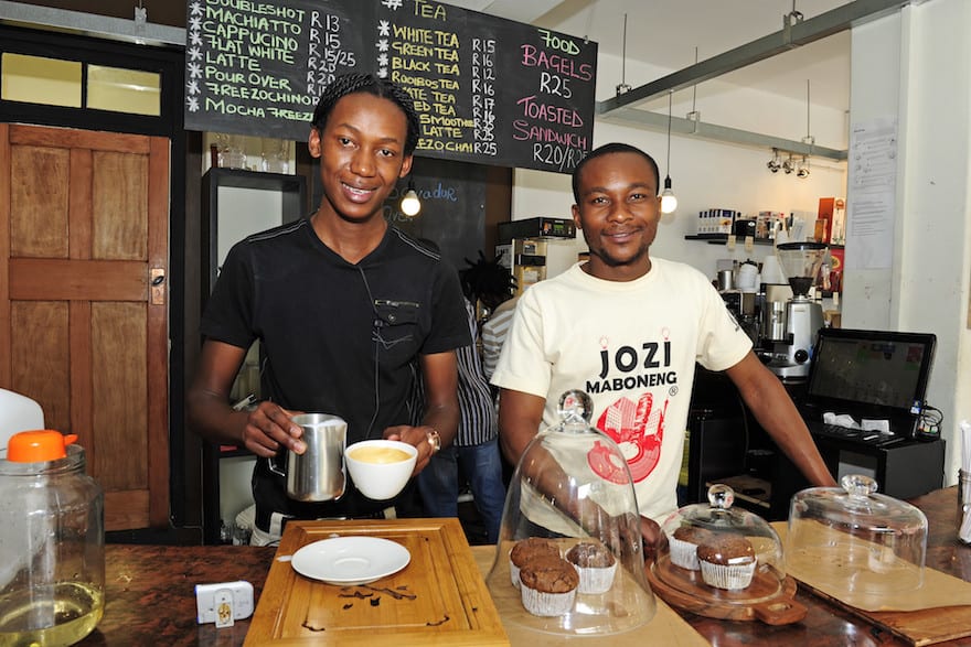 Smiling baristas behind the counter