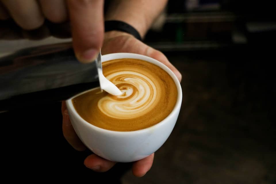 Pouring milk to make a cappuccino