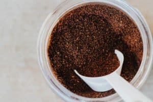 Ground coffee in a container with a scoop