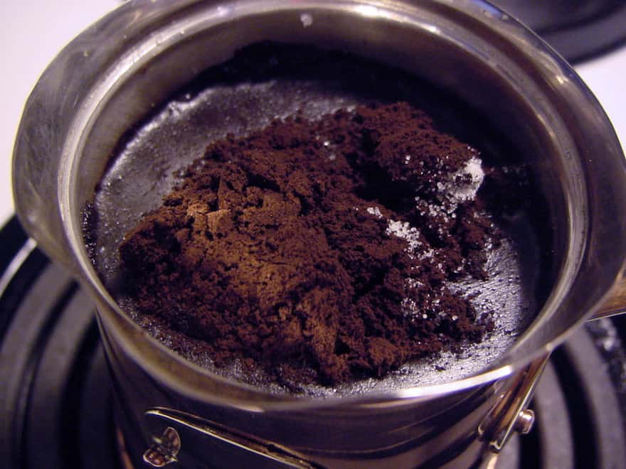 Coffee ground fine as powder is mixed with water in the Cezve.