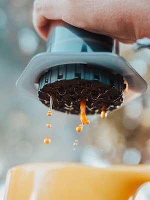 Coffee being extracted from the bottom of an Aeropress