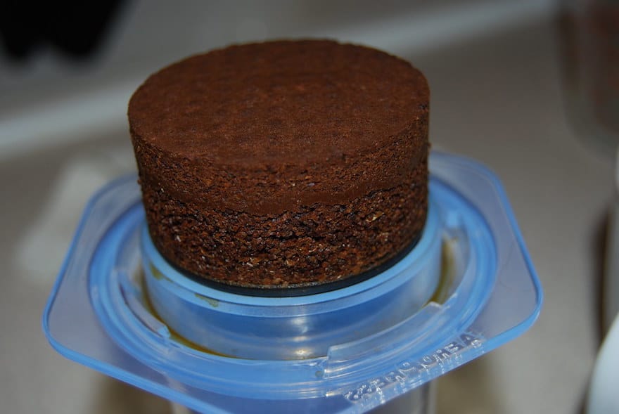 Puck of coffee grounds in the bottom of an Aeropress