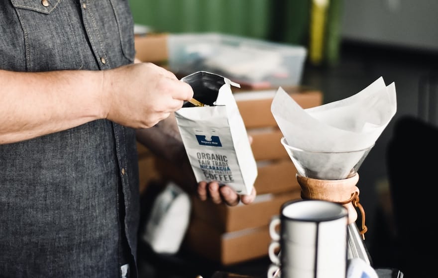 Scooping organic coffee into a filter