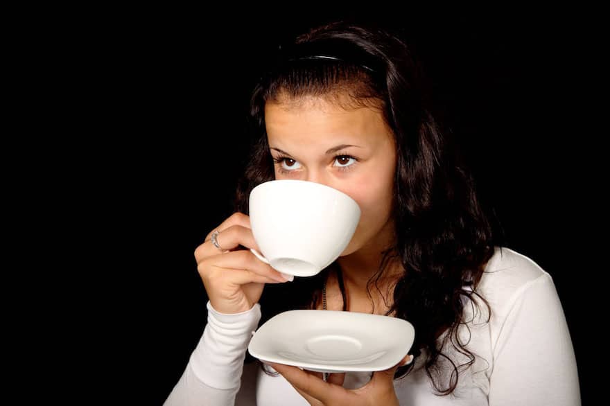 Young woman sipping coffee from a cup