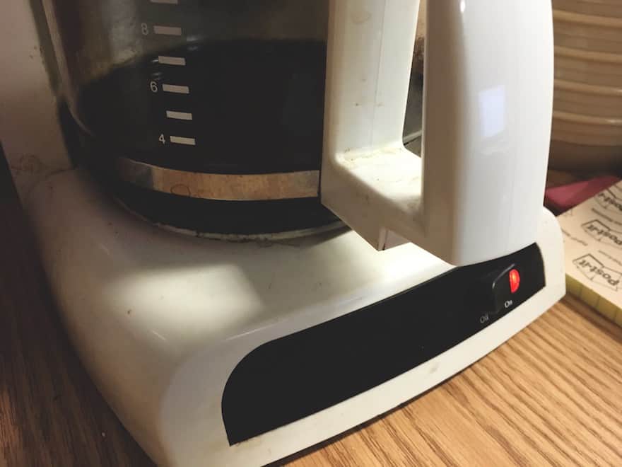 Old coffee maker sitting on a desk