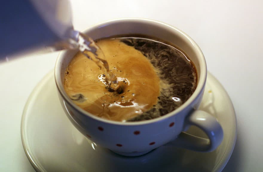 Pouring water into an Americano