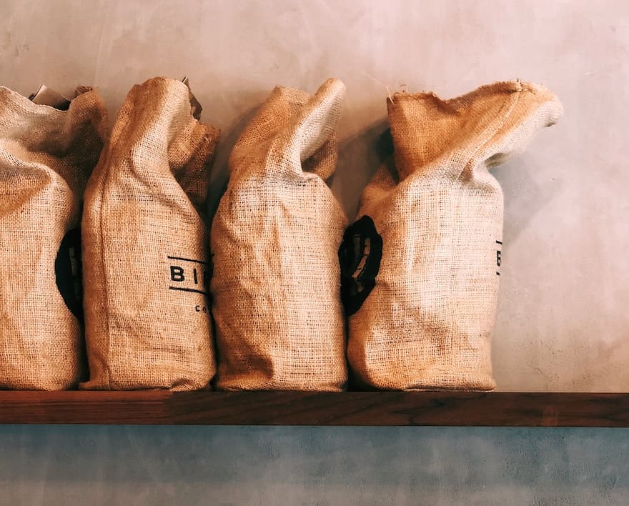 burlap sacks of coffee beans on a shelf