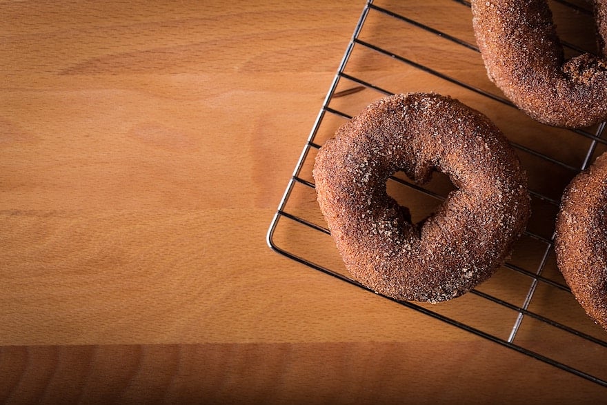 Overhead shot of donuts cooling on a wire rack