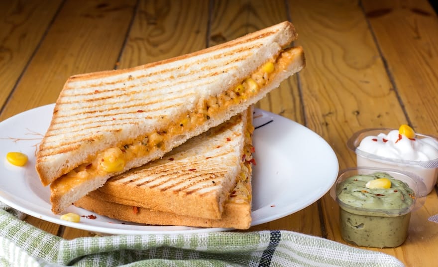 Grilled cheese sandwich cut into triangles on a white plate