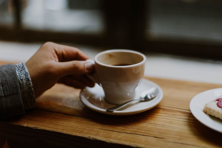 hand grasping an Americano cup