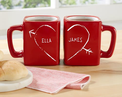 Set of red coffee mugs that make an image of a heart when placed side by side