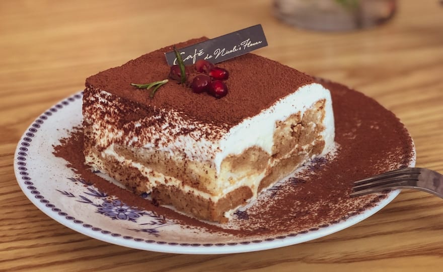 Piece of tiramisu on a white plate