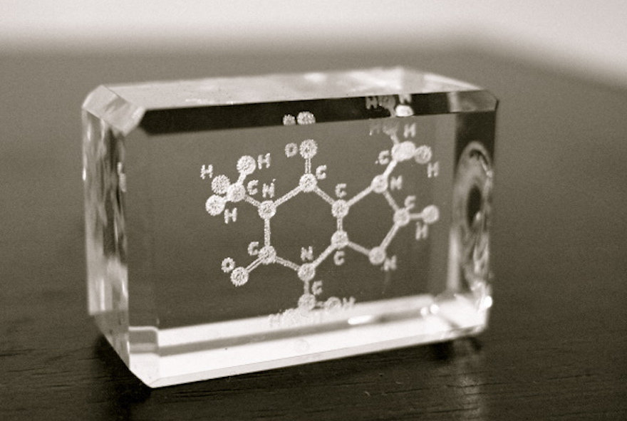 Sculpture of a caffeine molecule suspended in a brick of glass