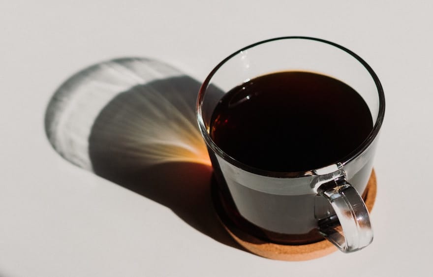 Dark coffee in a clear glass cup