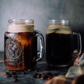 Two jars of cold brew coffee with ice
