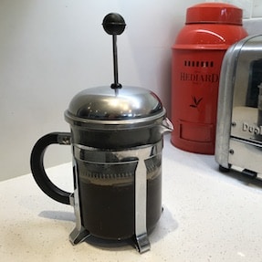 French press coffee steeping on a counter