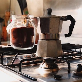 Moka pot coffee brewing on a gas stove
