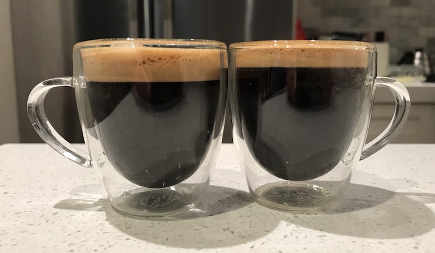 Two double shots of espresso, side by side on a counter