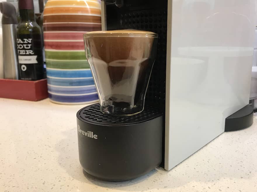 Long espresso brewing into a glass cup on a Nespresso Essenza Mini