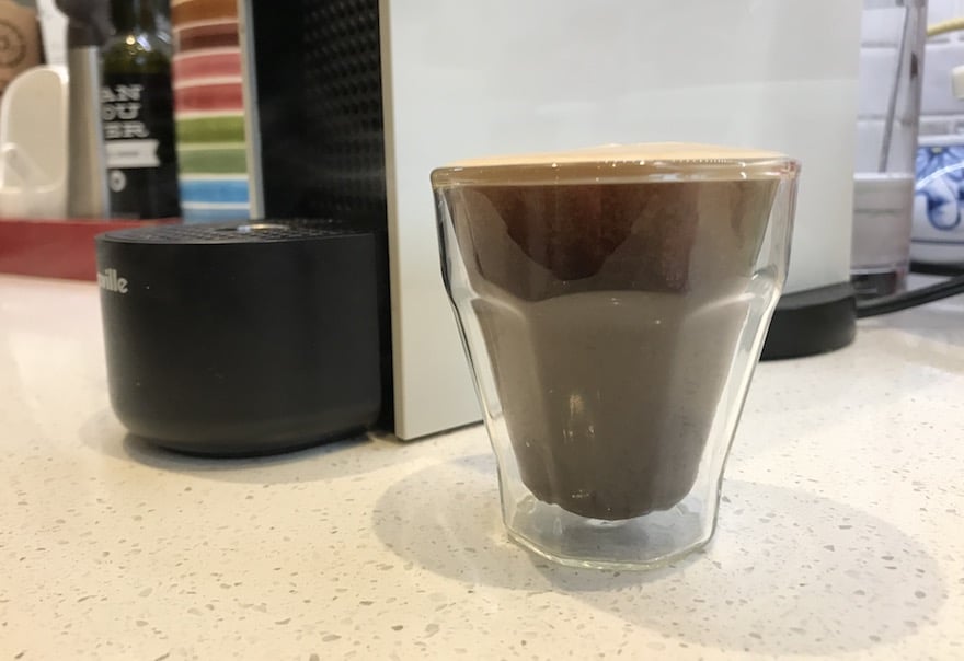 Long espresso next to a Nespresso machine
