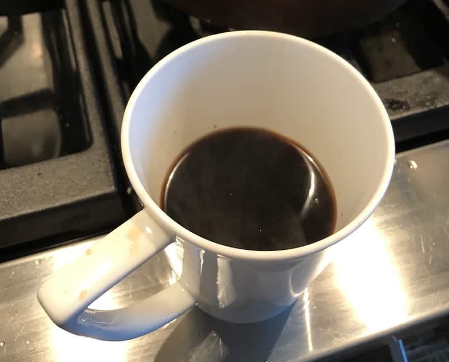Cup of coffee brewed from whole beans