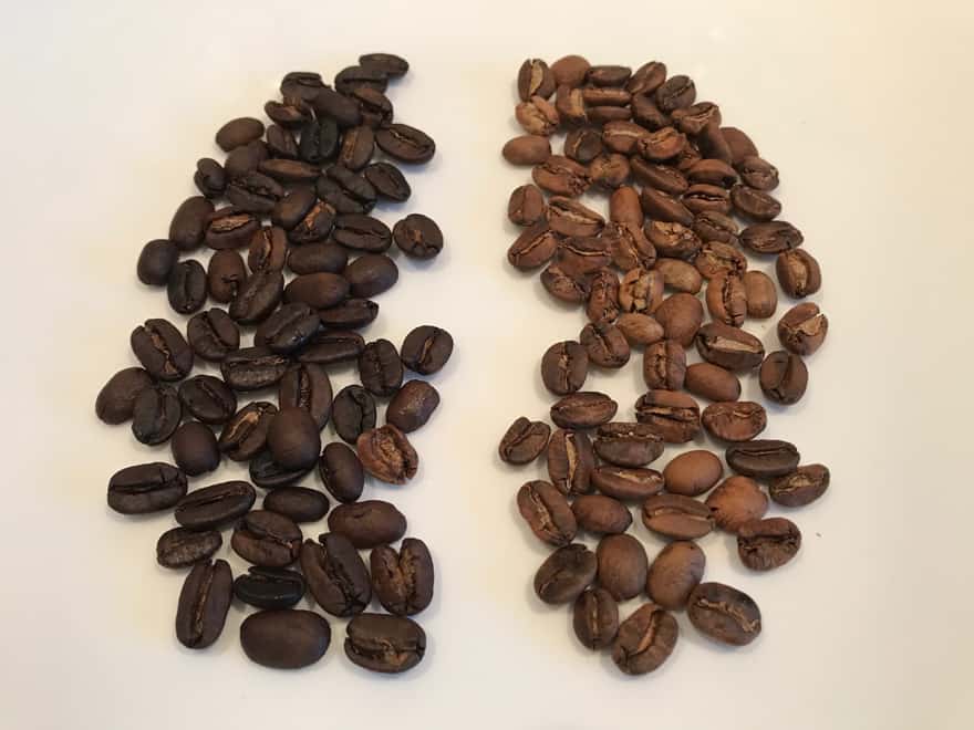 Dark roast coffee beans on the left and blonde roast coffee beans on the right