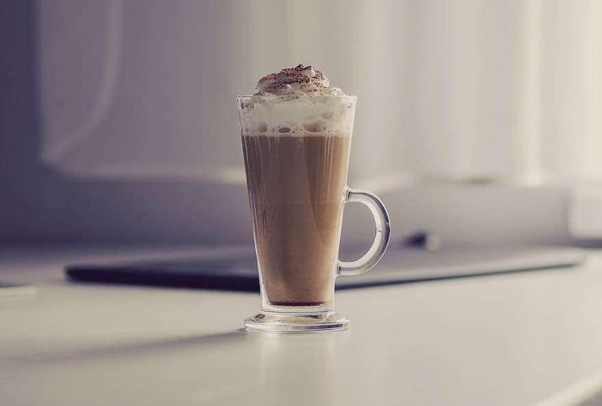 A nice blended beverage topped with whipped cream and sprinkles.