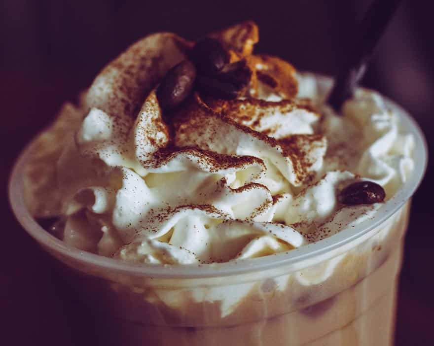 A Starbucks Frappuccino topped with whipped cream and cocoa dust