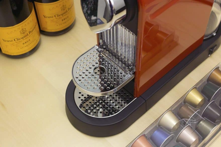 Container of capsules next to a Nespresso machine