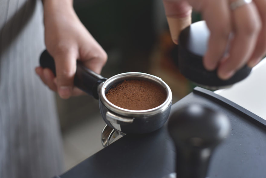 Tamping an espresso into a portafilter.