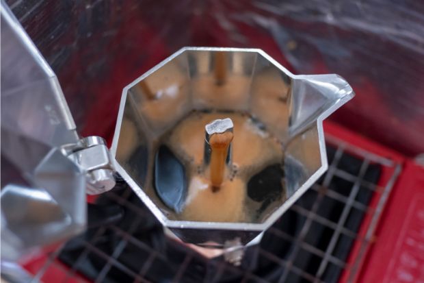 Coffee bubbling from the chimney into the upper chamber of a moka pot