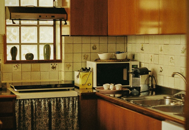 Microwave on a counter next to a Nespresso machine