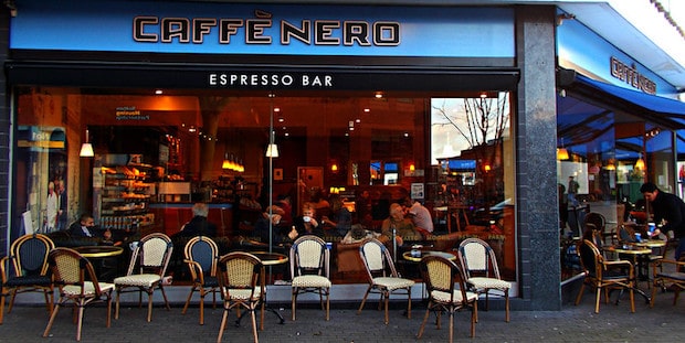 Sidewalk tables and chairs outside a Caffe Nero espresso bar in London
