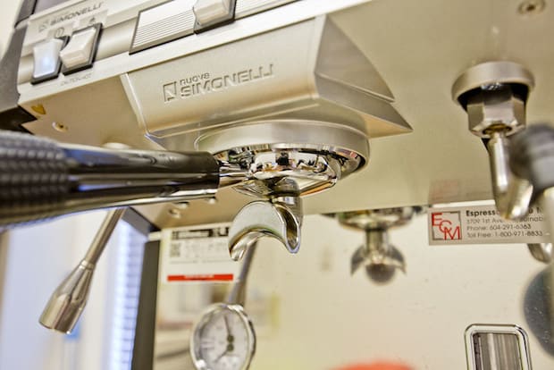 Closeup of the brew group on a Nuova Simonelli espresso machine