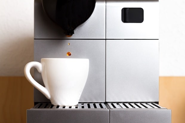 Coffee dripping into a cup from a Nespresso machine