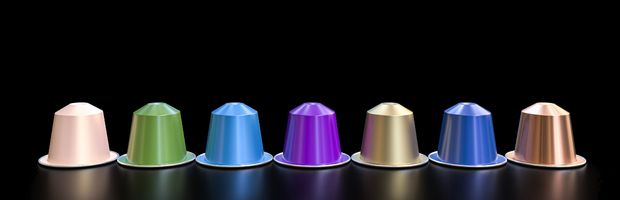 Eight Nespresso capsules on black background