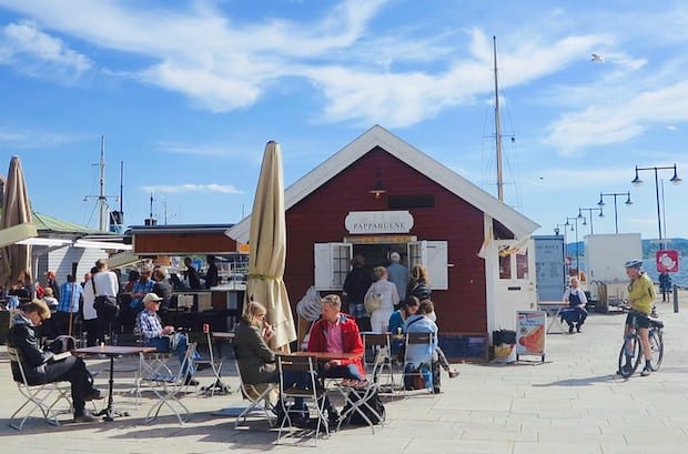 Waterfront sidewalk cafe in Oslo under a blue sky