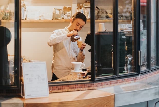 Japanese barista at a coffee takeout window