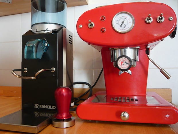 The Rancilio Rocky espresso grinder next to an espresso machine on a counter