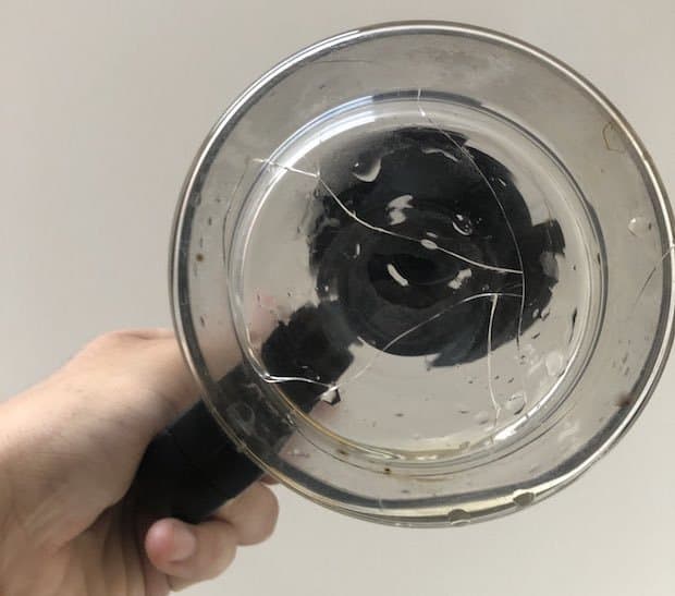 Bottom view of a cracked glass coffee pot