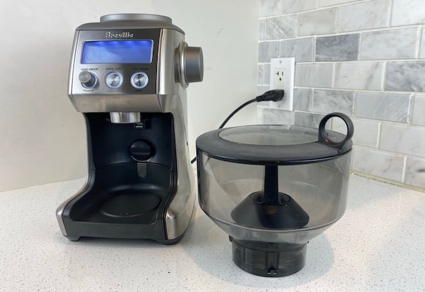 Breville Smart Grinder Pro on the counter with the bean hopper removed and resting on the counter in the foreground