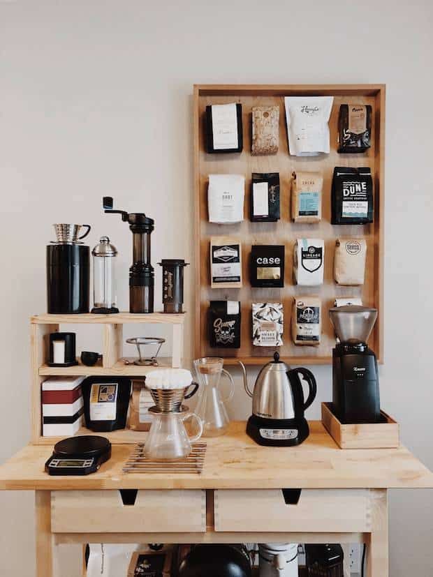 coffee station featuring a crate-like shelving unit on the surface