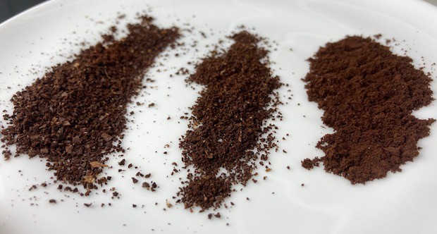 Plate with three piles of coffee grounds in different size particles