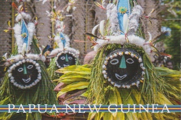 Postcard from Papua New Guinea showing traditional dolls or puppets