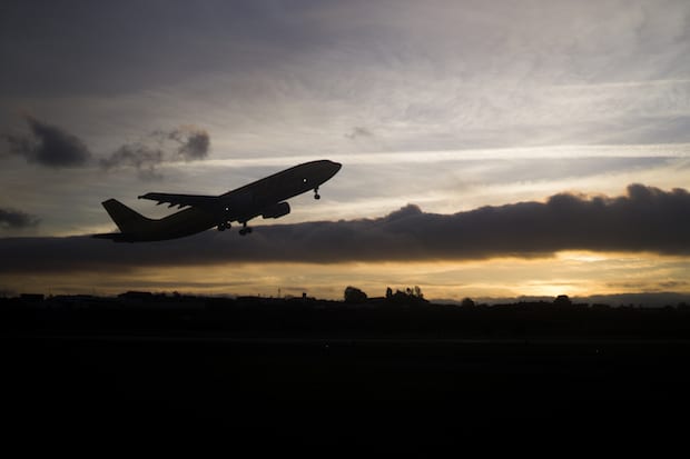 Silhouette of an airplane taking off at dusk