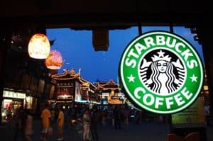 Starbucks sign glows above a Shanghai streetscape