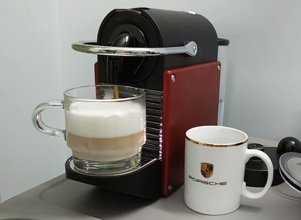 Nespresso Pixie holds a freshly brewed cappuccino