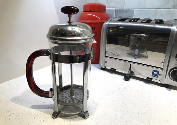 Empty French press on a counter